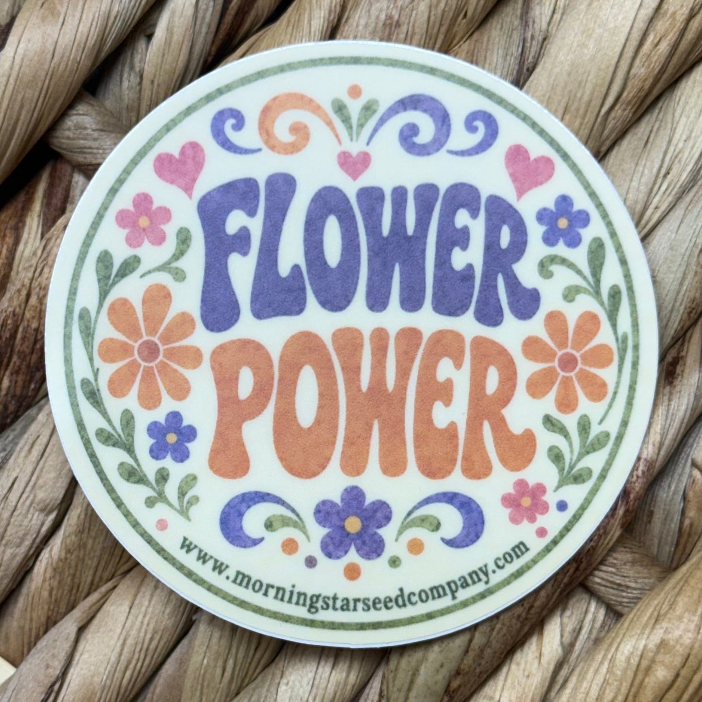 A  round sticker with the phrase 'flower power.