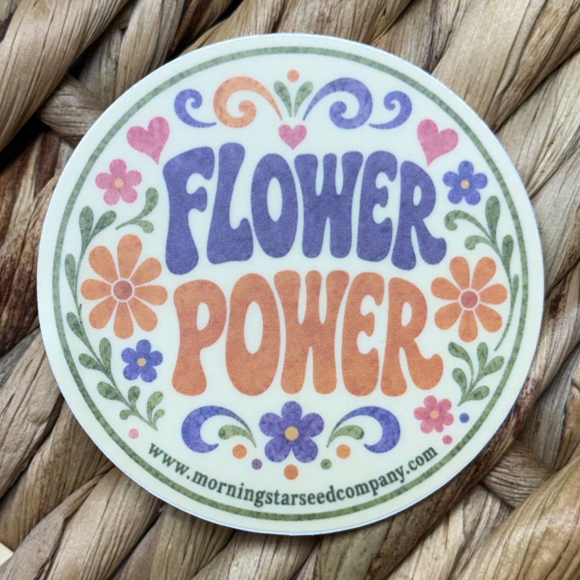 A  round sticker with the phrase 'flower power.